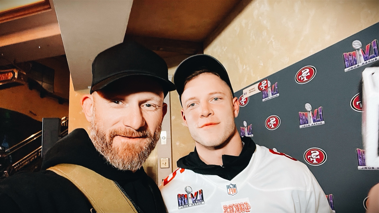 Justin Howard with Christian McCaffrey during Super Bowl LVIII media week