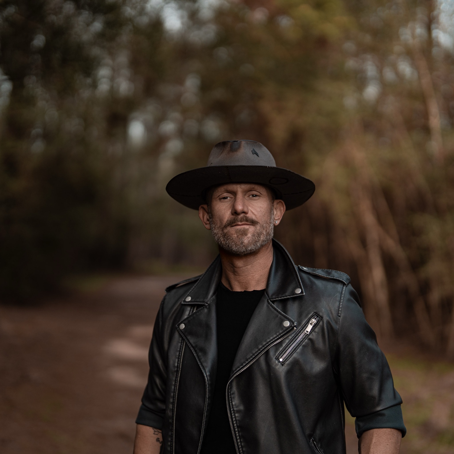 Justin Howard in a hat and leather jacket
