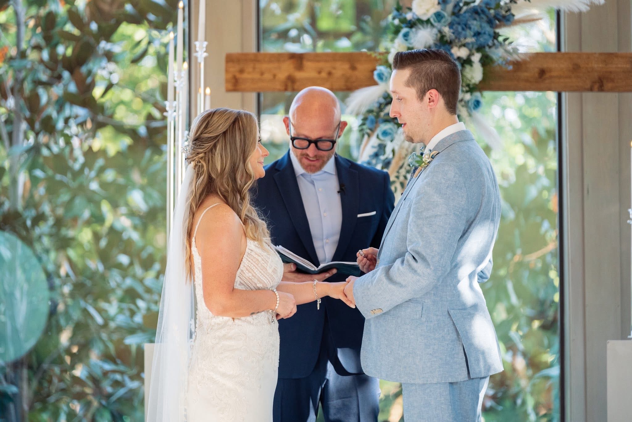 Justin Howard officiating a wedding as a couple shares their vows