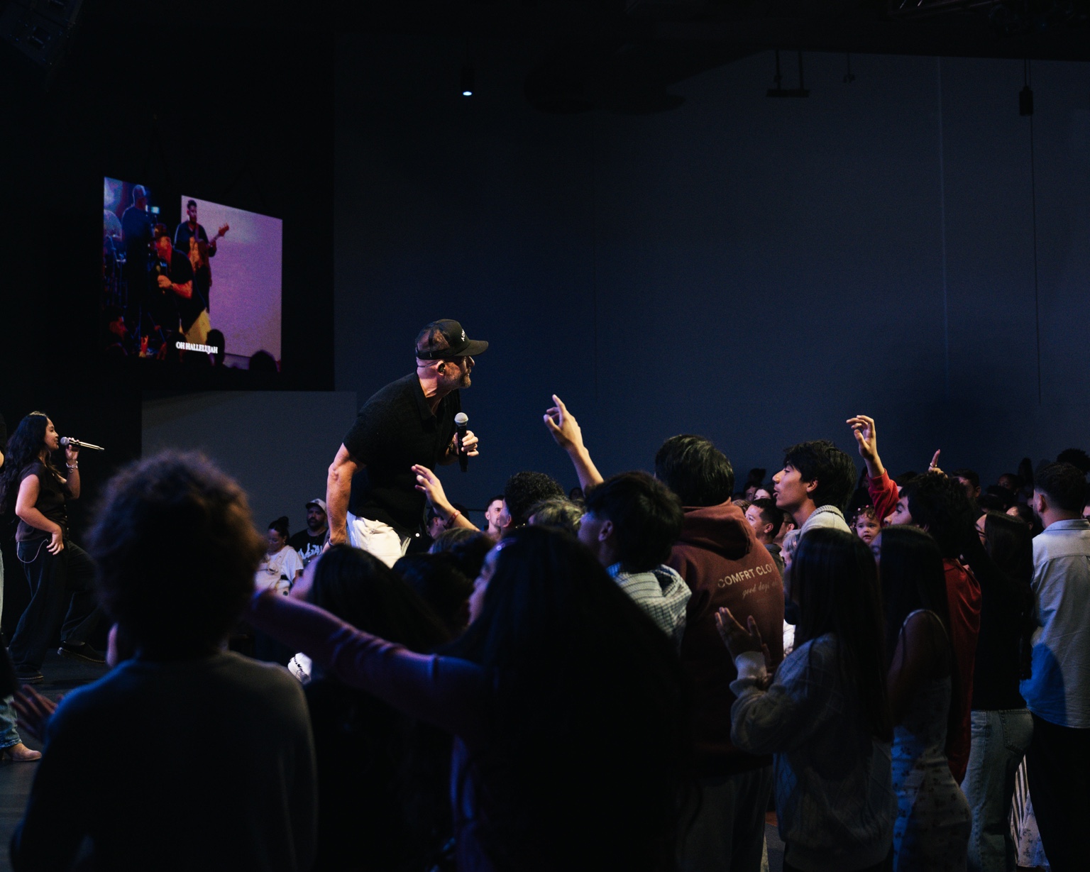 Justin leading worship among a gathered crowd