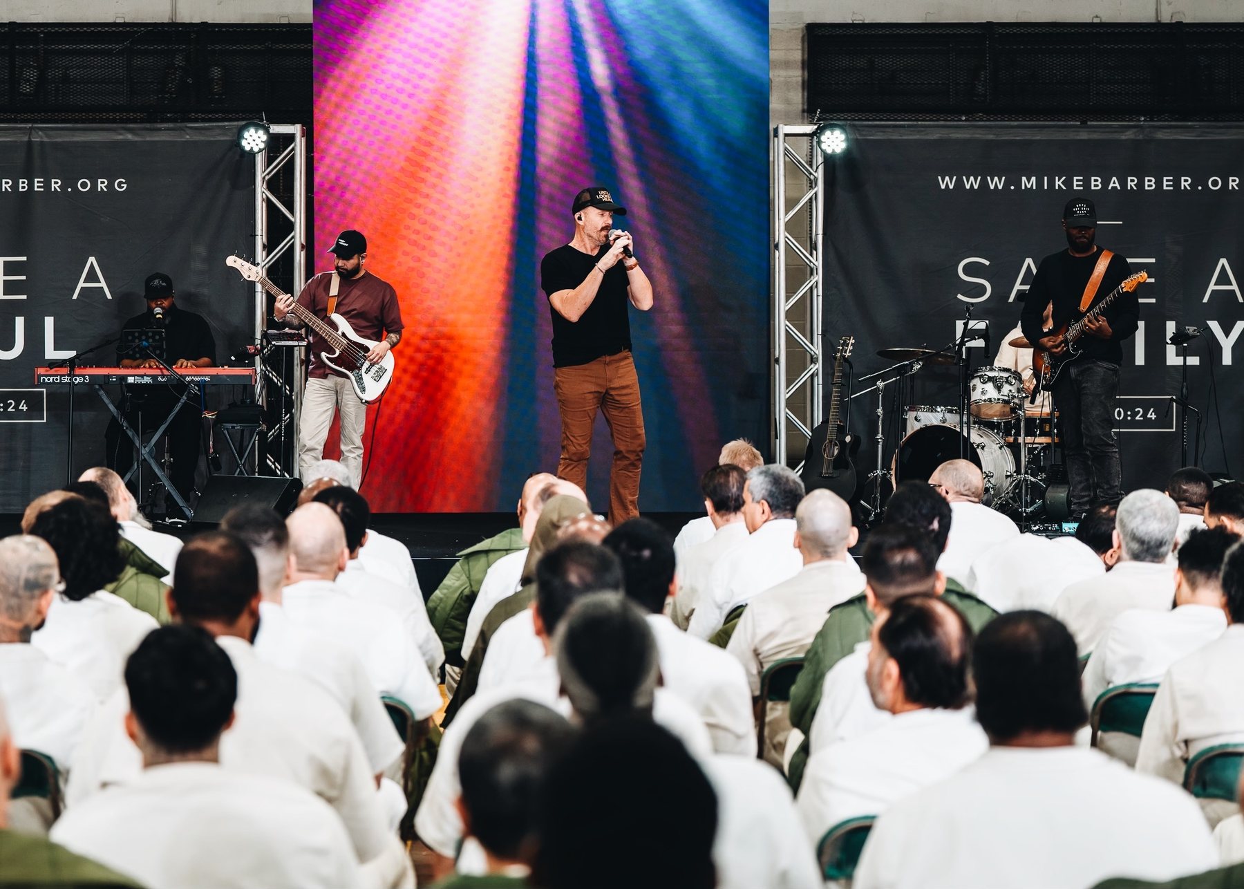 Worship team on stage before a seated congregation