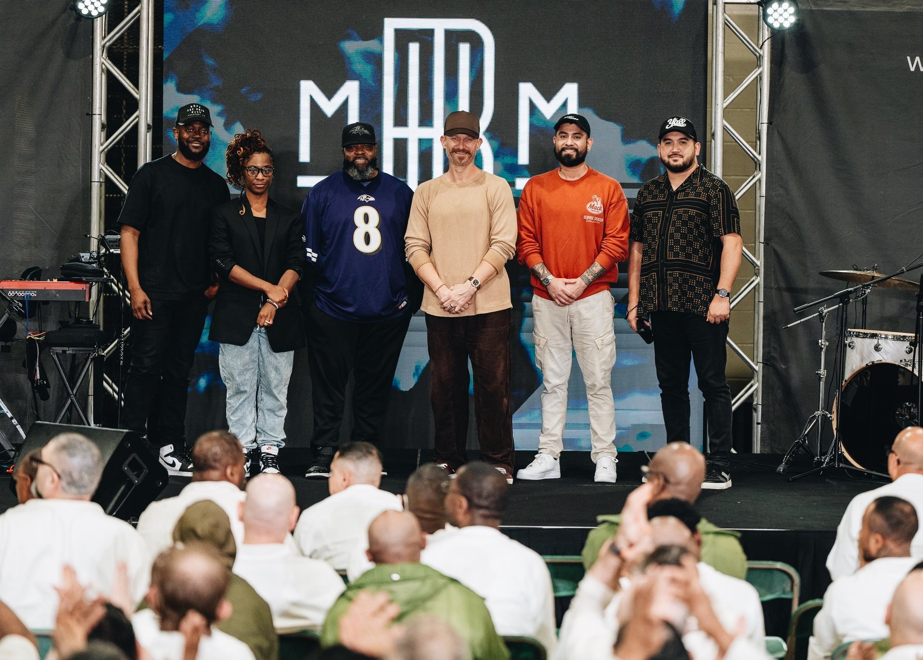 Justin standing on stage with members of a ministry team