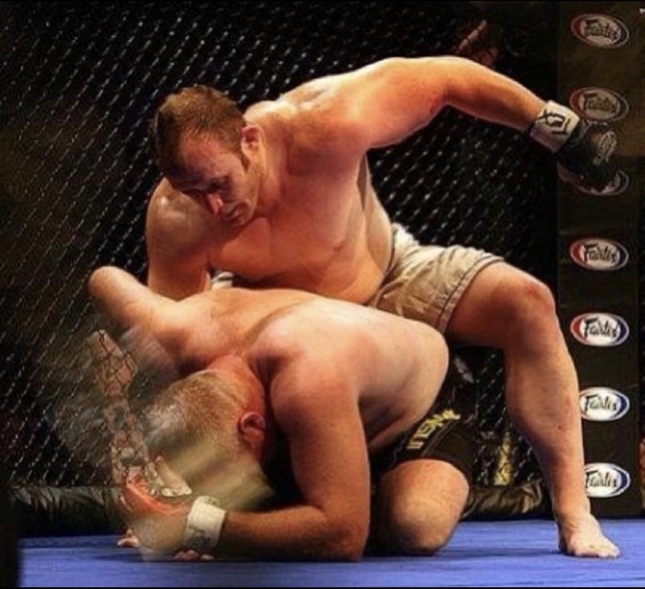 Justin competing in an MMA fight at 245 pounds