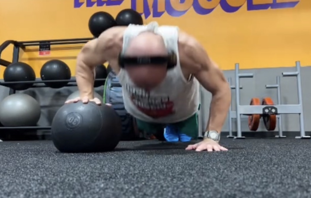Justin performing a medicine ball push-up during strength training