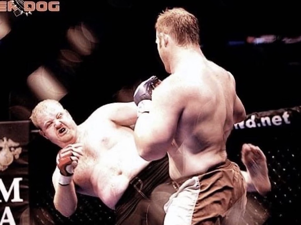 Justin landing a kick during a professional MMA fight